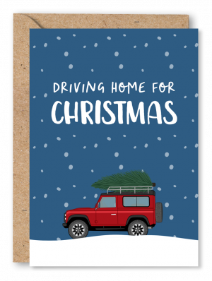 A Christmas card featuring a Land Rover defender carrying a Christmas tree on it’s roof, driving over snow on a snowy navy blue background. White text above the Land Rover reads ‘Driving home for Christmas’