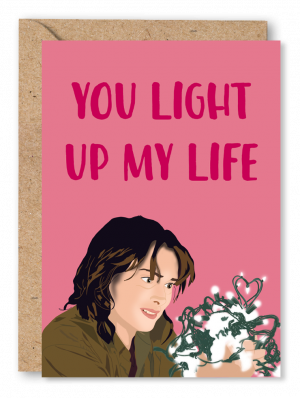 A pink Valentine’s Card featuring Joyce Byers from Stranger Things and the text ‘You light up my life’