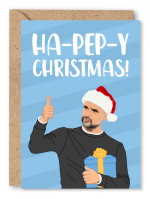 A light blue Christmas card featuring Manchester City boss Pep Guardiola with his thumb up, wearing a Santa hat and holding a present. White text at the top of the card reads ‘Ha-Pep-y Christmas!’