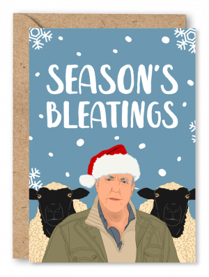 A blue Christmas card featuring an illustration of Jeremy Clarkson wearing a Santa hat with two sheep behind him. White text above reads ‘Season’s Bleatings’