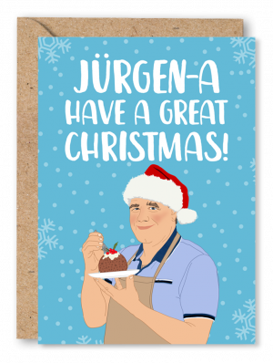 A blue Christmas card featuring an illustration of a Great British Bake Off Contestant Jurgen, wearing a party Santa hat, eating a Christmas pudding. White text above reads ‘Jurgen-a Have a Great Christmas!’